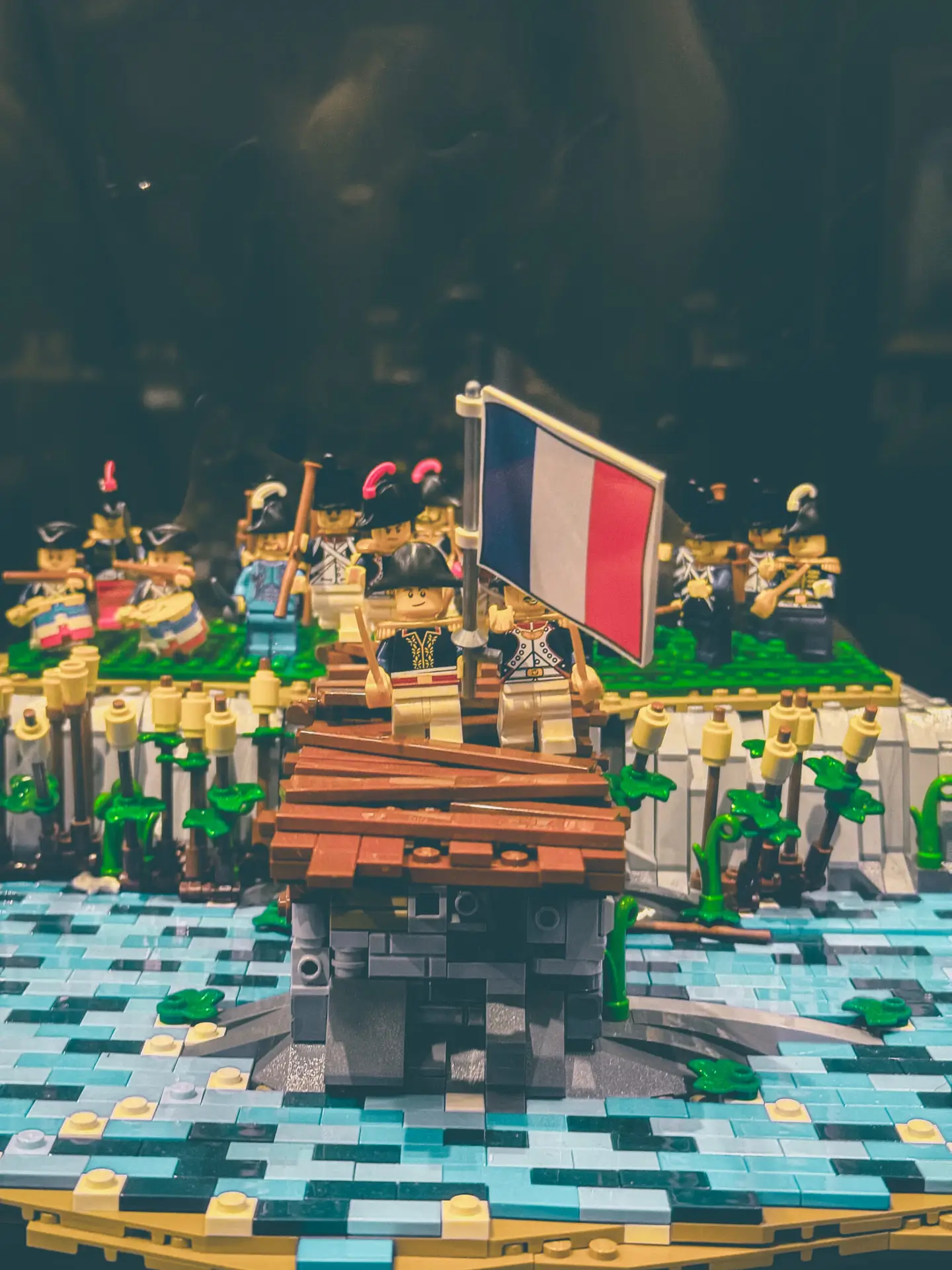 LEGO build of the Battle of the Arcole Bridge: a wooden bridge over blue brick water with the tricolour raised amid grenadiers.