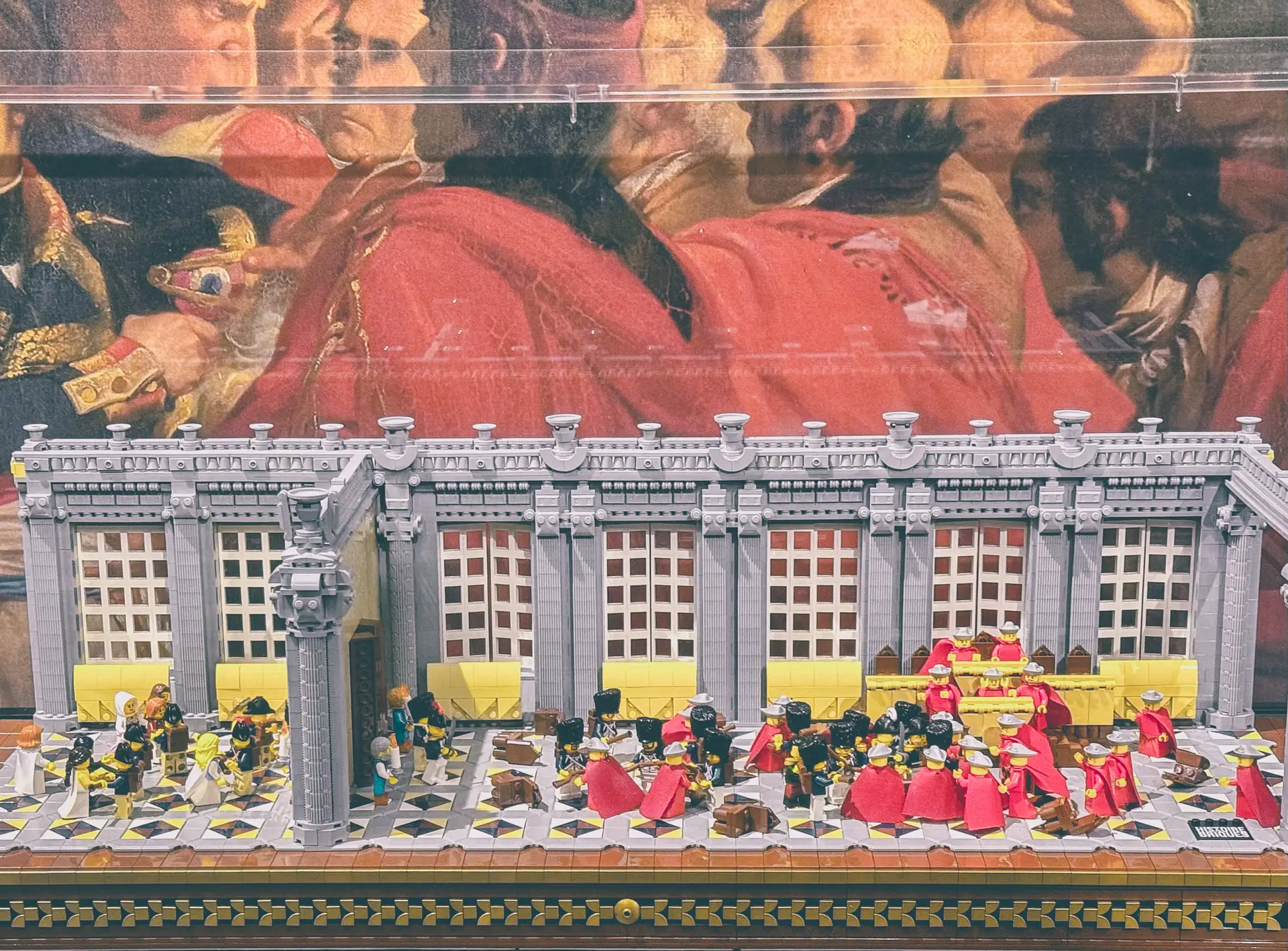 LEGO build of the long colonnaded Orangery at Saint-Cloud lined with deputies, set against a painted backdrop of the coup.