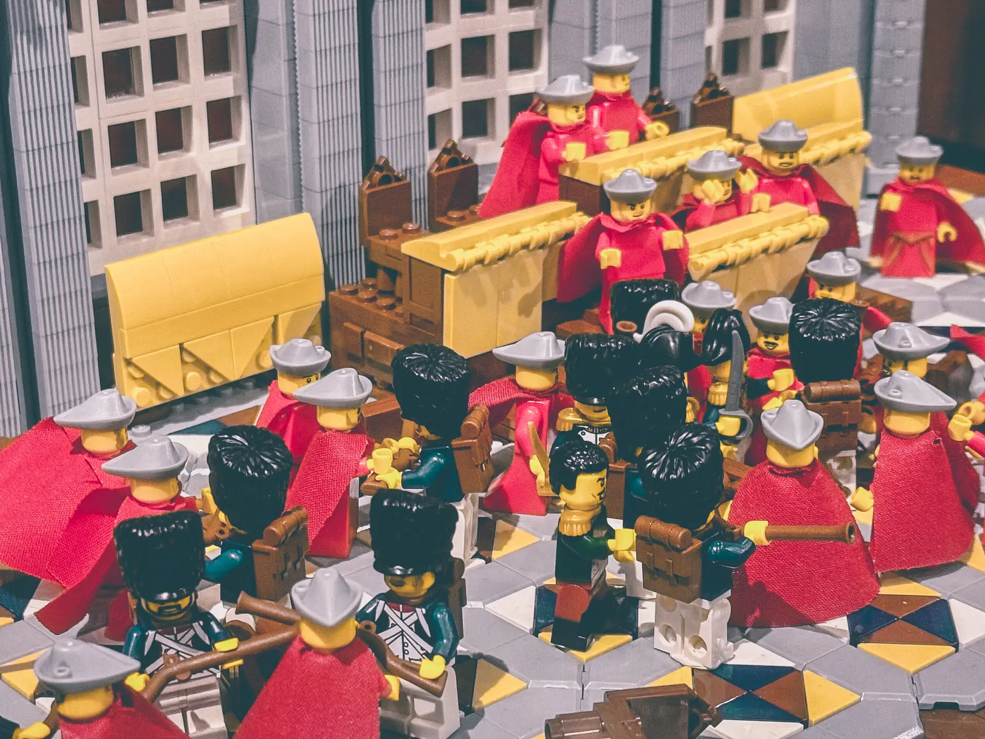Close view of the LEGO coup build showing rows of Council of Five Hundred deputies in red capes among grenadiers in bearskins.