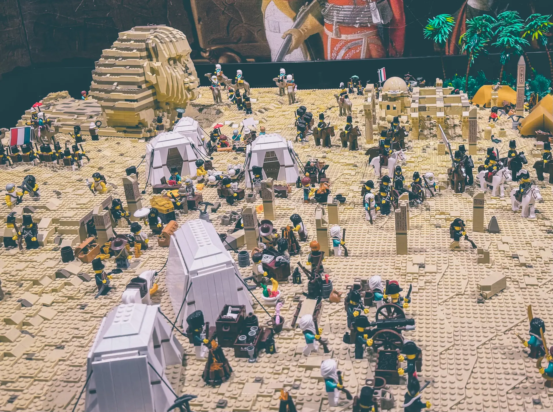 LEGO Egyptian campaign diorama with white tents, palm trees and massed French troops below the brick-built pyramid.