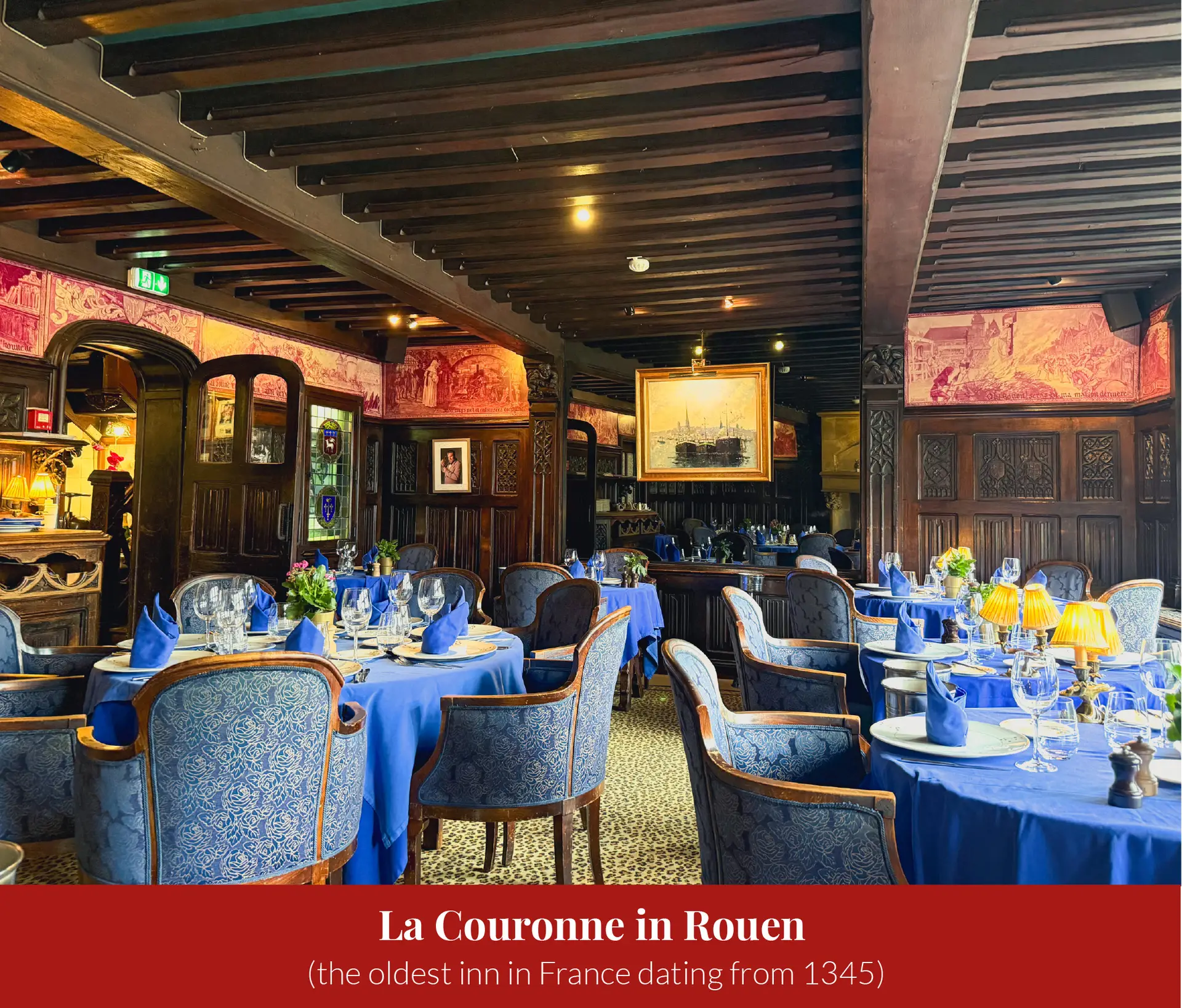 Wood-panelled dining room at La Couronne in Rouen with exposed beams, painted friezes, and tables set with blue linens and wine glasses.