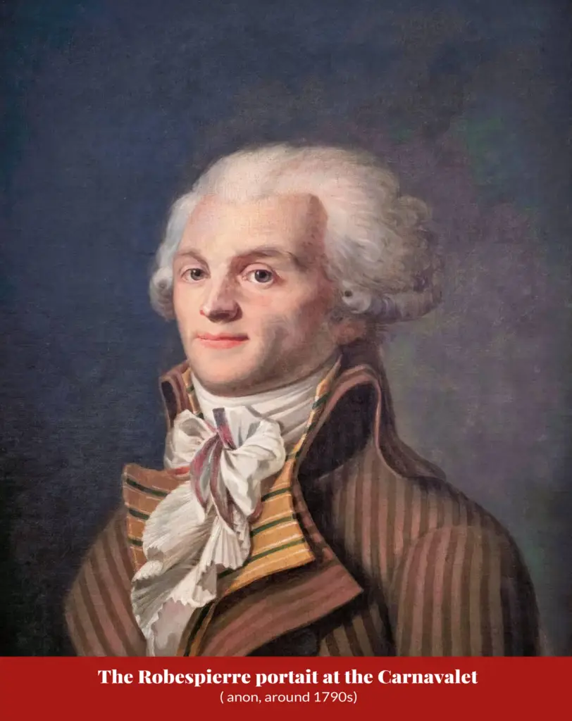 Oil portrait of a man with powdered hair and blue eyes wearing a striped brown-and-gold coat with a knotted white cravat, against a dark blue-grey background; captioned ‘The Robespierre portait at the Carnavalet (anon, around 1790s)’.