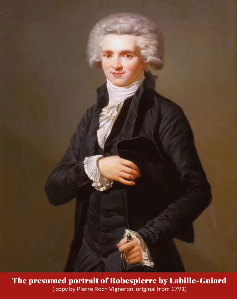 Oil portrait of a man in a black coat holding a tricorne hat and spectacles, with a powdered curled wig; captioned ‘The presumed portrait of Robespierre by Labille-Guiard (copy by Pierre Roch Vigneron, original from 1791)’.