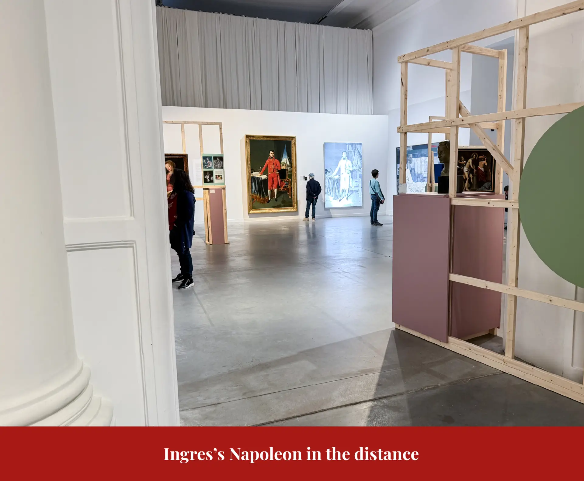 Gallery view at La Boverie with Ingres's Napoleon hanging small in the distance beyond a partition.